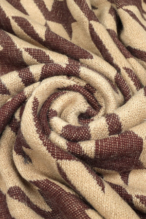 Houndstooth faux fur collar poncho in beige with brown pattern detail.