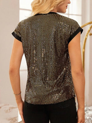 Gold sequin cap sleeve blouse with black trim, styled with black pants.