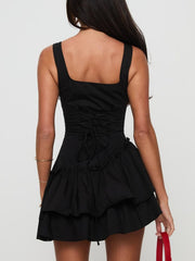 Black mini dress with square neckline, lace-up back, and tiered ruffled skirt.