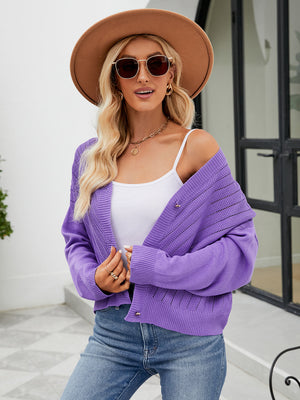 Purple cropped V-neck knit cardigan with button details and open knit pattern.