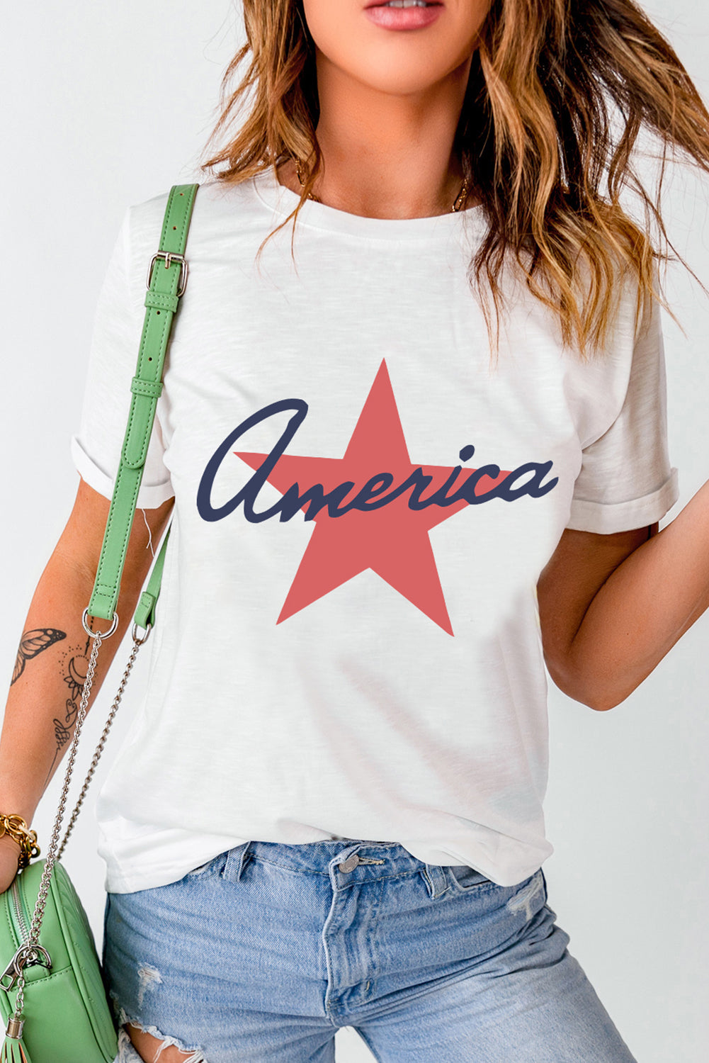 White t-shirt with red star and blue script "America" graphic.