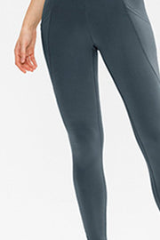 Dark gray performance leggings with side pockets and a sculpted fit.