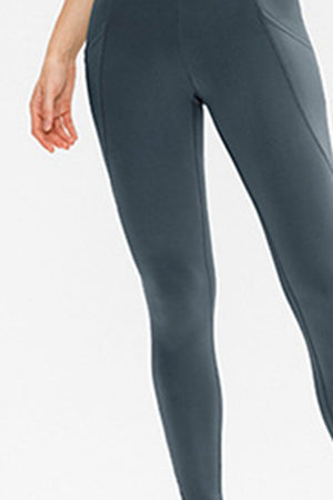 Dark gray performance leggings with side pockets and a sculpted fit.