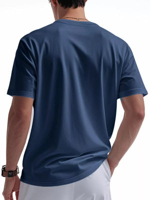 Men's casual t-shirt in Denim Blue, short sleeves, crew neck, with a buttoned pocket detail.