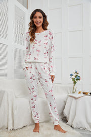 White flamingo print loungewear set with long sleeves and jogger pants.