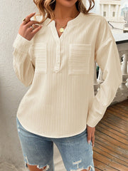Textured henley blouse in cream with two chest pockets and a button placket.