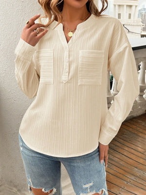 Textured henley blouse in cream with two chest pockets and a button placket.
