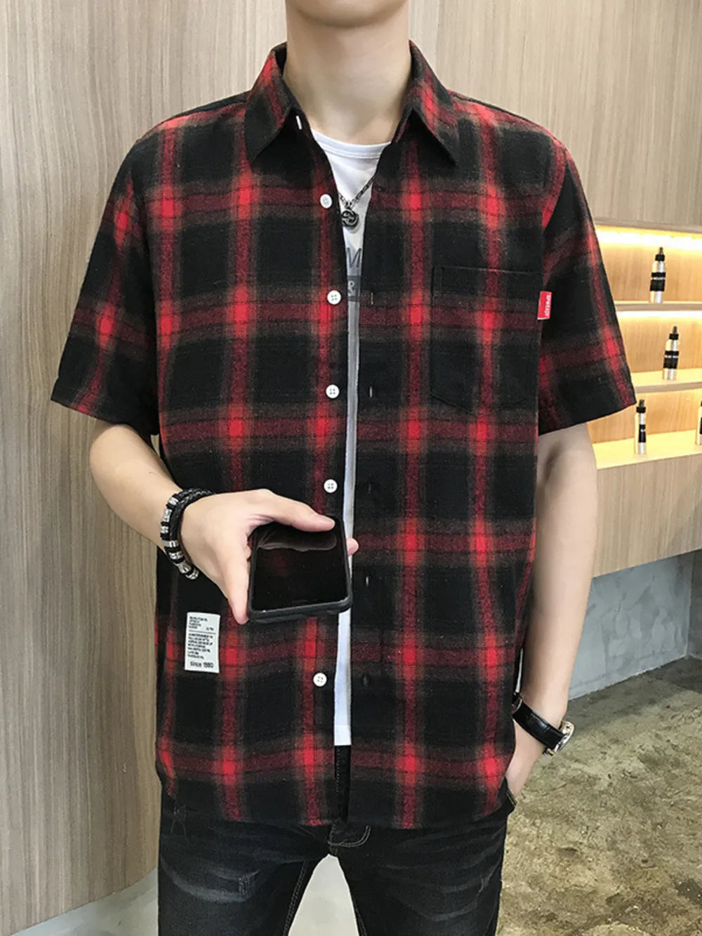 Red and black plaid short sleeve button-down overshirt with chest pocket.