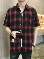 Red and black plaid short sleeve button-down overshirt with chest pocket.