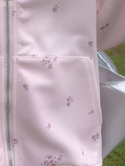 Pink floral zip-up sweatshirt with a chest pocket and subtle floral pattern.