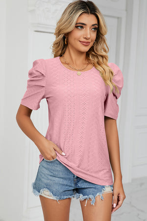 Perforated puff sleeve top in blush pink with a textured diamond pattern.