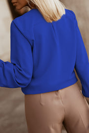 Royal Blue pleated yoke blouse with button detail and long sleeves.