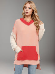 Waffle knit hooded tunic with colorblock design, contrast pocket, and long sleeves.
