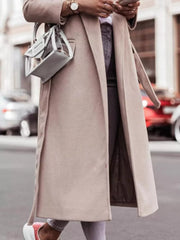 Belted longline trench coat in apricot with flap pockets and a tie belt.