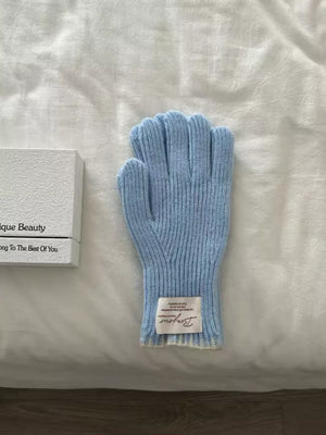 Blue ribbed knit gloves with scalloped cuff and a Bonjour label