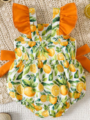 Baby bubble romper with orange and lemon print, ruffled sleeves, and side ties.