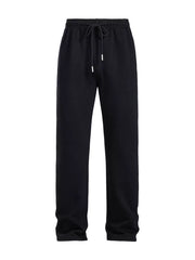 Men's black drawstring loose fit sweatpants with elastic waistband and metal-tipped cord.