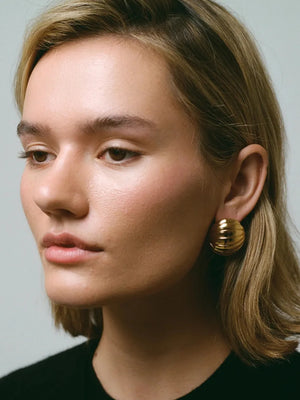 Gold dome earrings with ribbed texture, 18K gold-plated.