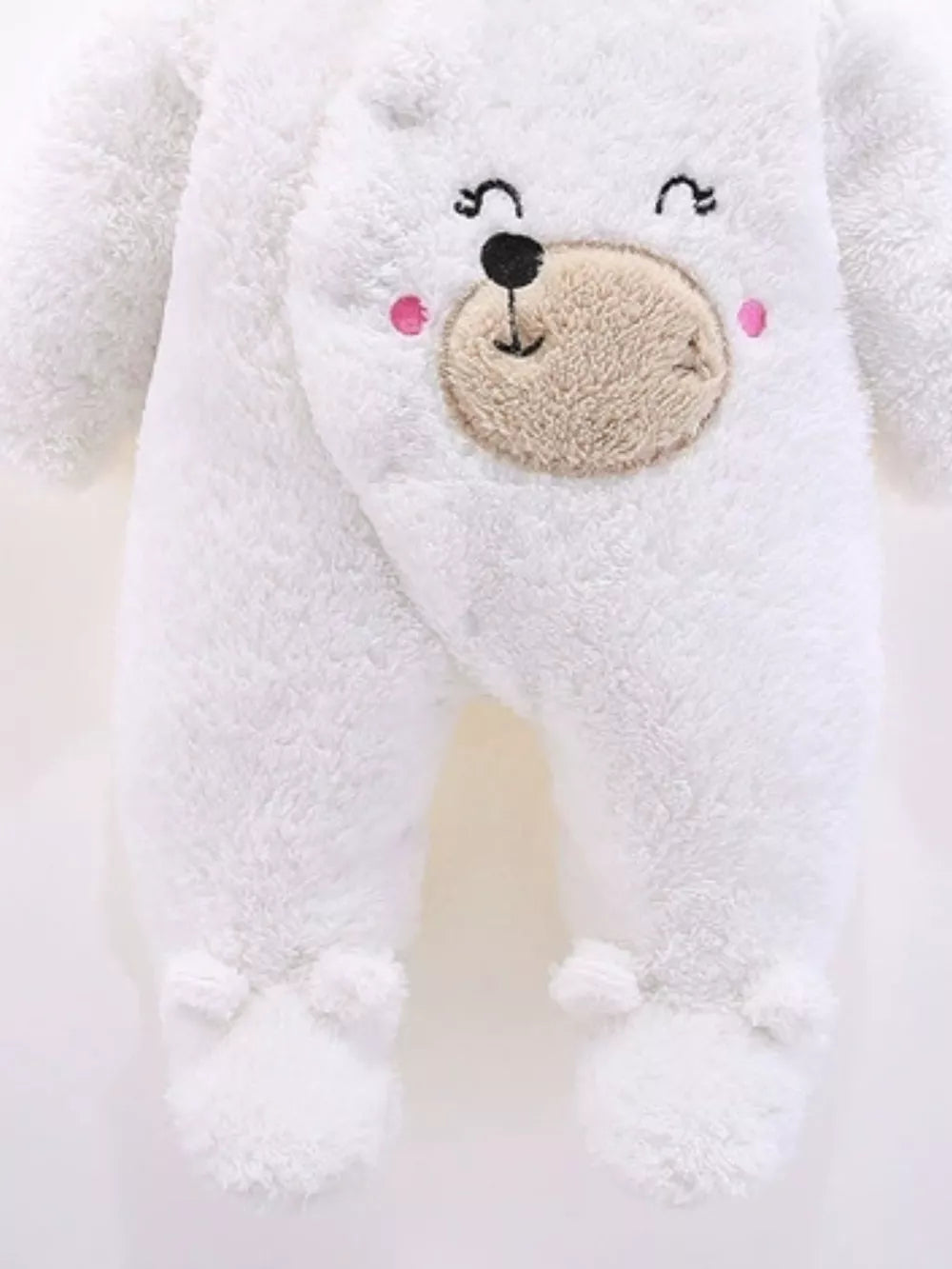 White plush baby one-piece with embroidered bear face and footie paws.