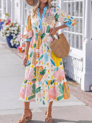 Midi dress with 3/4 sleeves, elastic waist, and tiered hem in a whimsical floral doodle print.