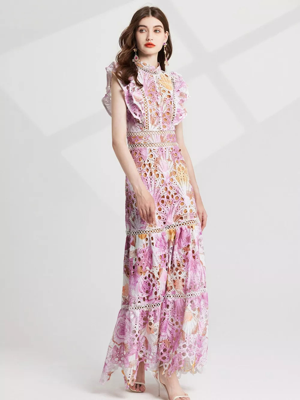 Pink floral lace maxi gown with cutout details and ruffled sleeves.
