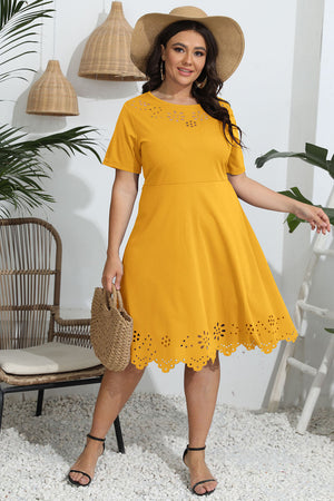Mustard yellow midi dress with laser cutout details on neckline and hem.