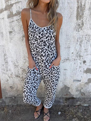 Leopard print slouchy cami jumpsuit in white with black spots, featuring spaghetti straps and pockets.
