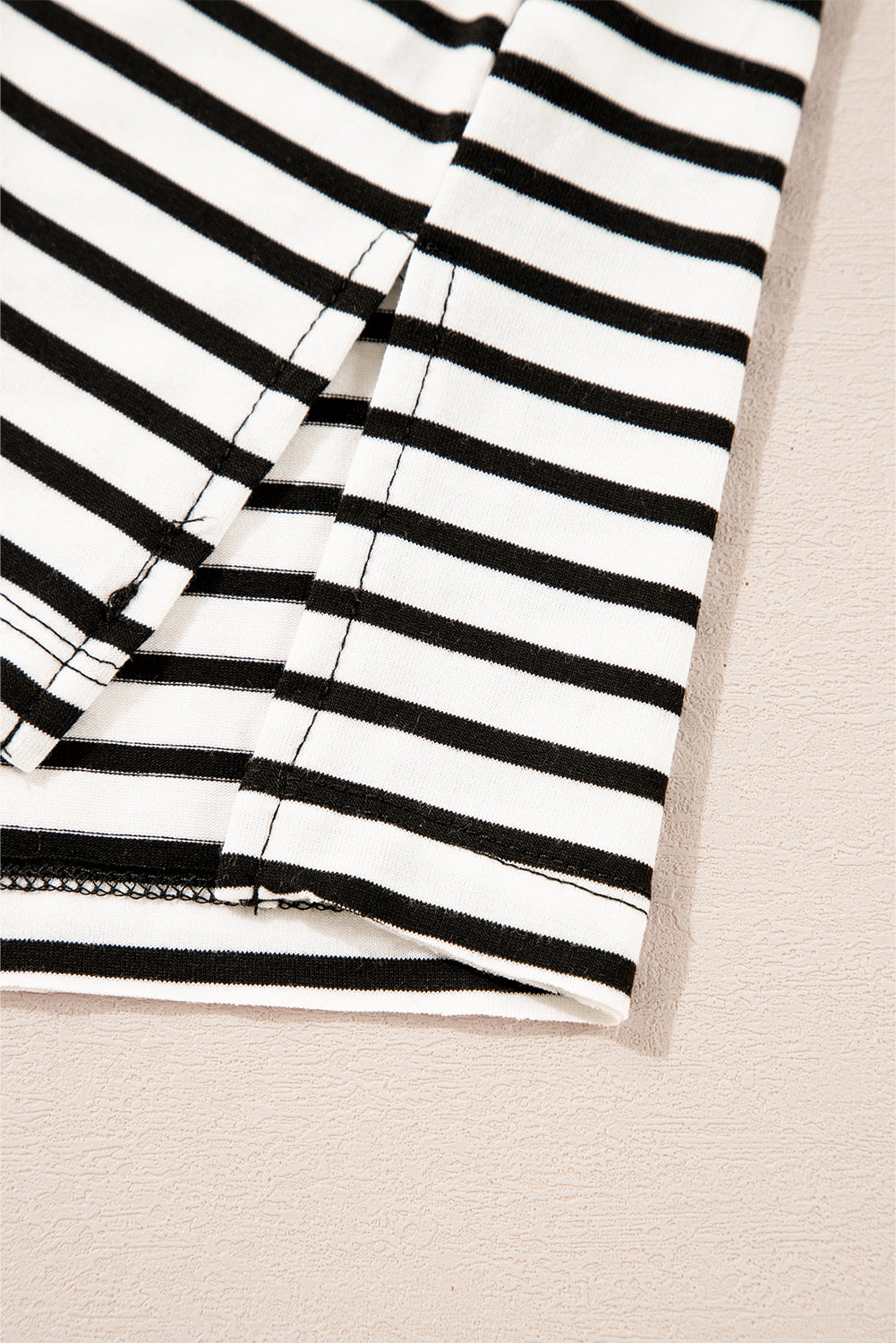 Black and white striped t-shirt with side slit detail.