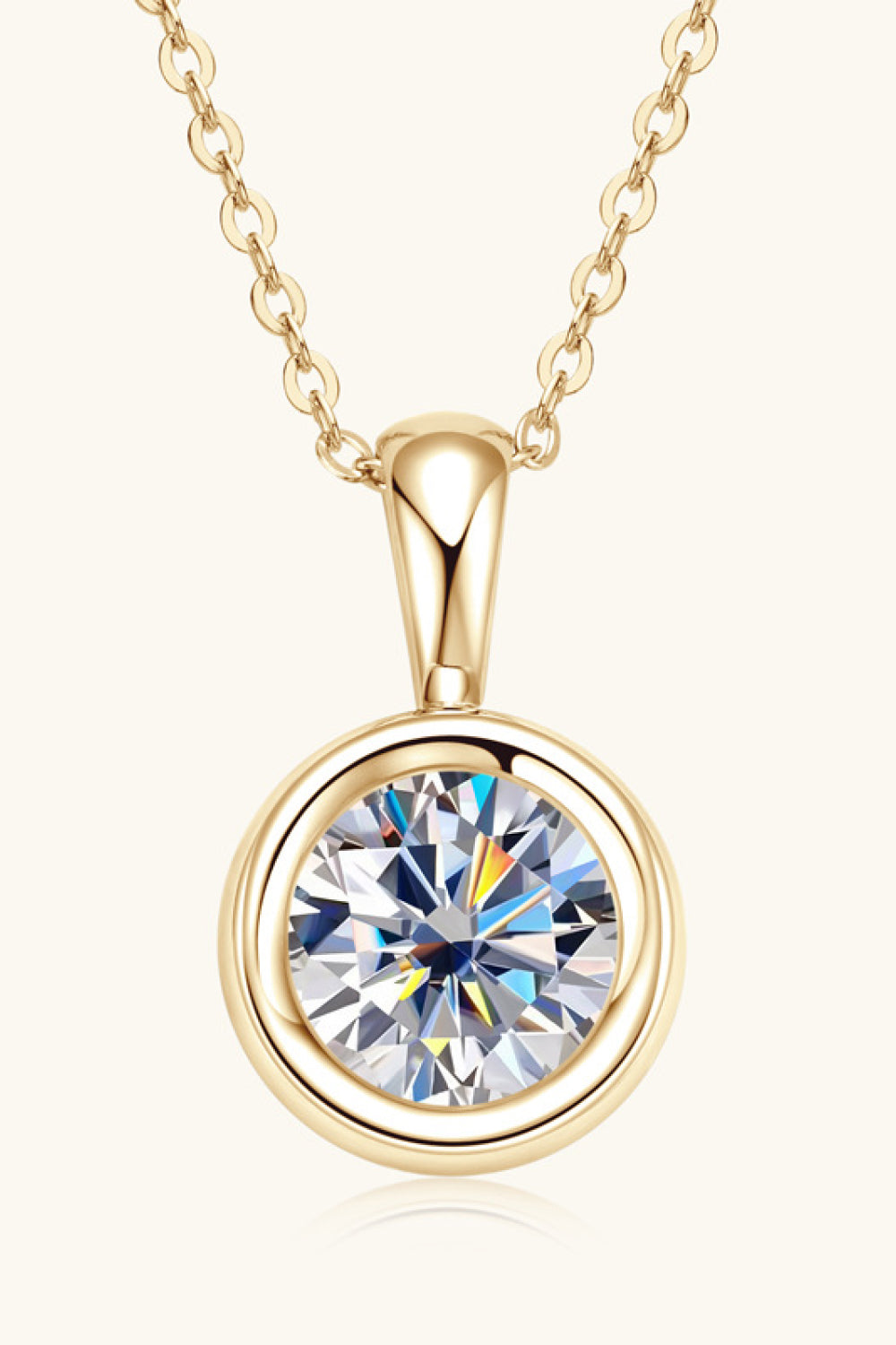 Gold solitaire bezel pendant necklace with a clear, faceted gemstone.