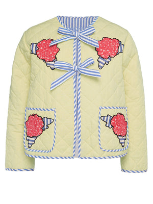 Pastel yellow quilted jacket with floral appliqué, blue striped trim, and bow closures.