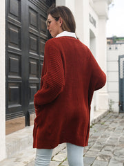 Burgundy ribbed knit cocoon cardigan with pockets and a relaxed fit.