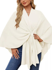 Ivory knit cape top with tie front and draped elegance, V-neck, wide sleeves.