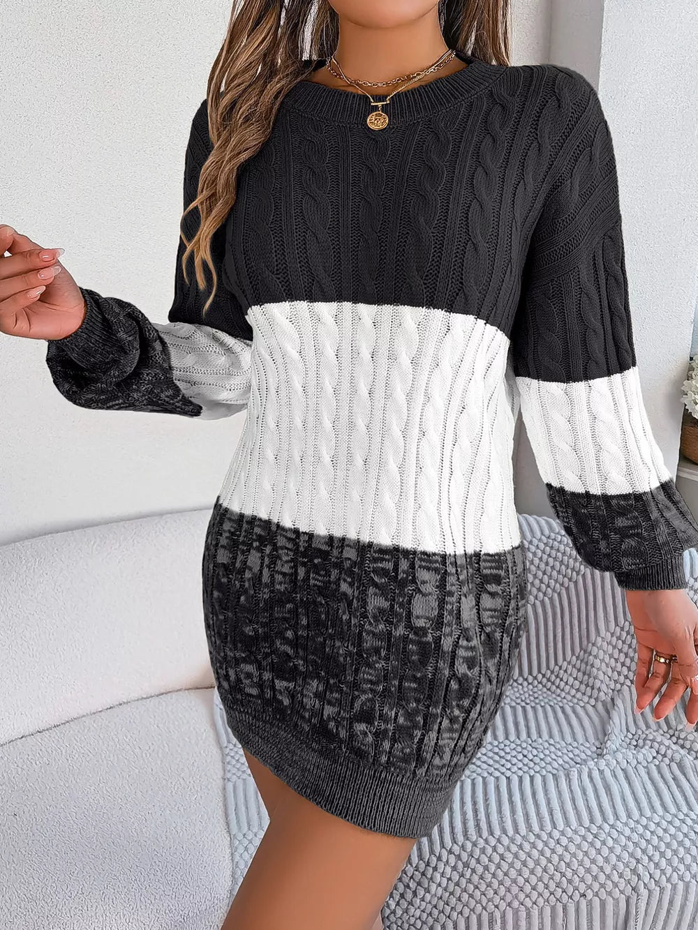 Textured cable knit sweater dress with colorblock design in black, white, and grey.