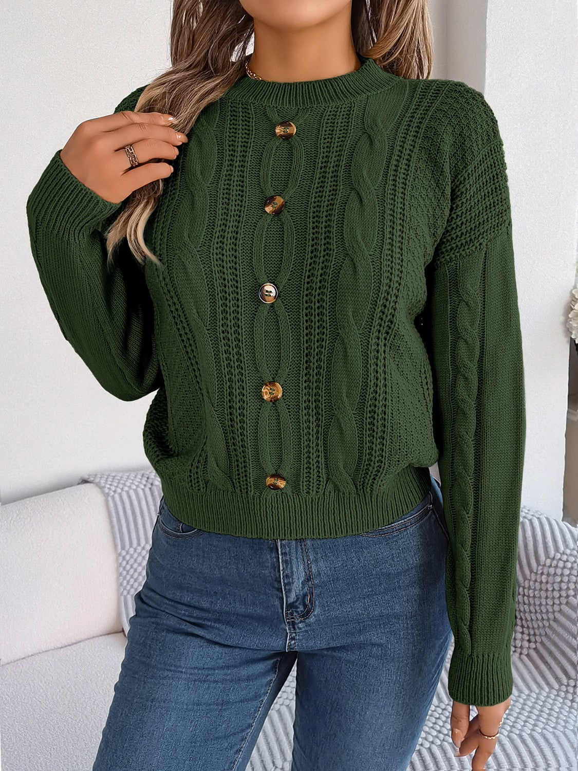 Army green cable knit button-up sweater with wood-look buttons.
