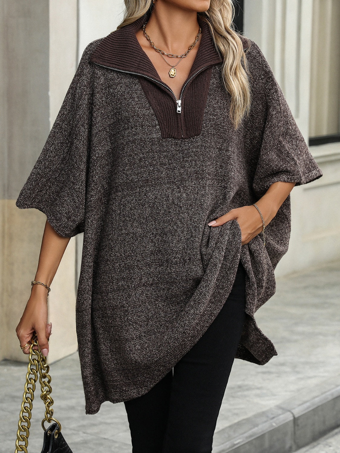 Asymmetric knit zip-neck poncho in coffee brown with short sleeves and a relaxed fit.