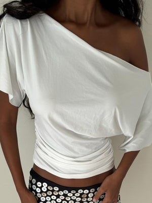 White ruched one shoulder t-shirt with asymmetrical neckline and dolman sleeves.