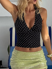 Black polka dot halter cami with deep V-neck and cropped length.