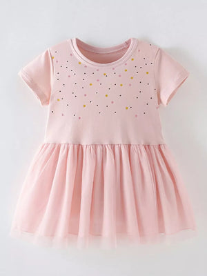 Blush pink toddler dress with scattered confetti dots and a layered tulle skirt.