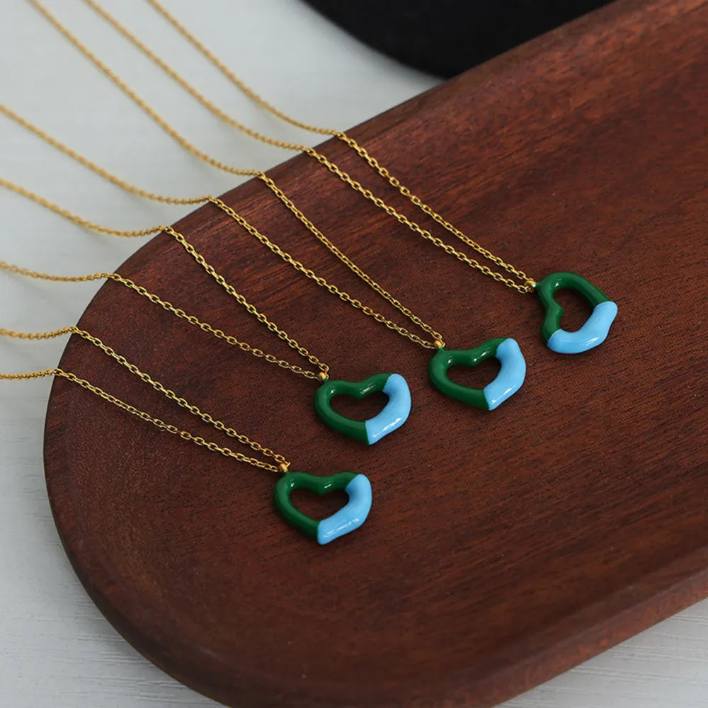 Two-tone heart enamel necklace with gold chain, green and light blue detail
