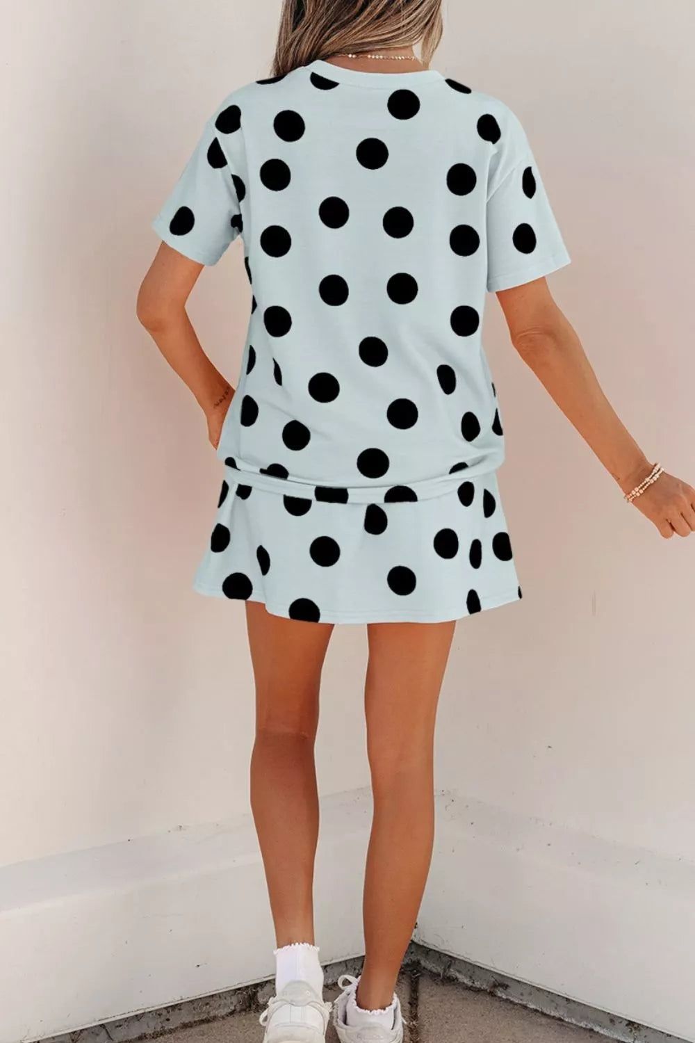Light blue polka dot two-piece outfit set with crew neck top and mini skirt.