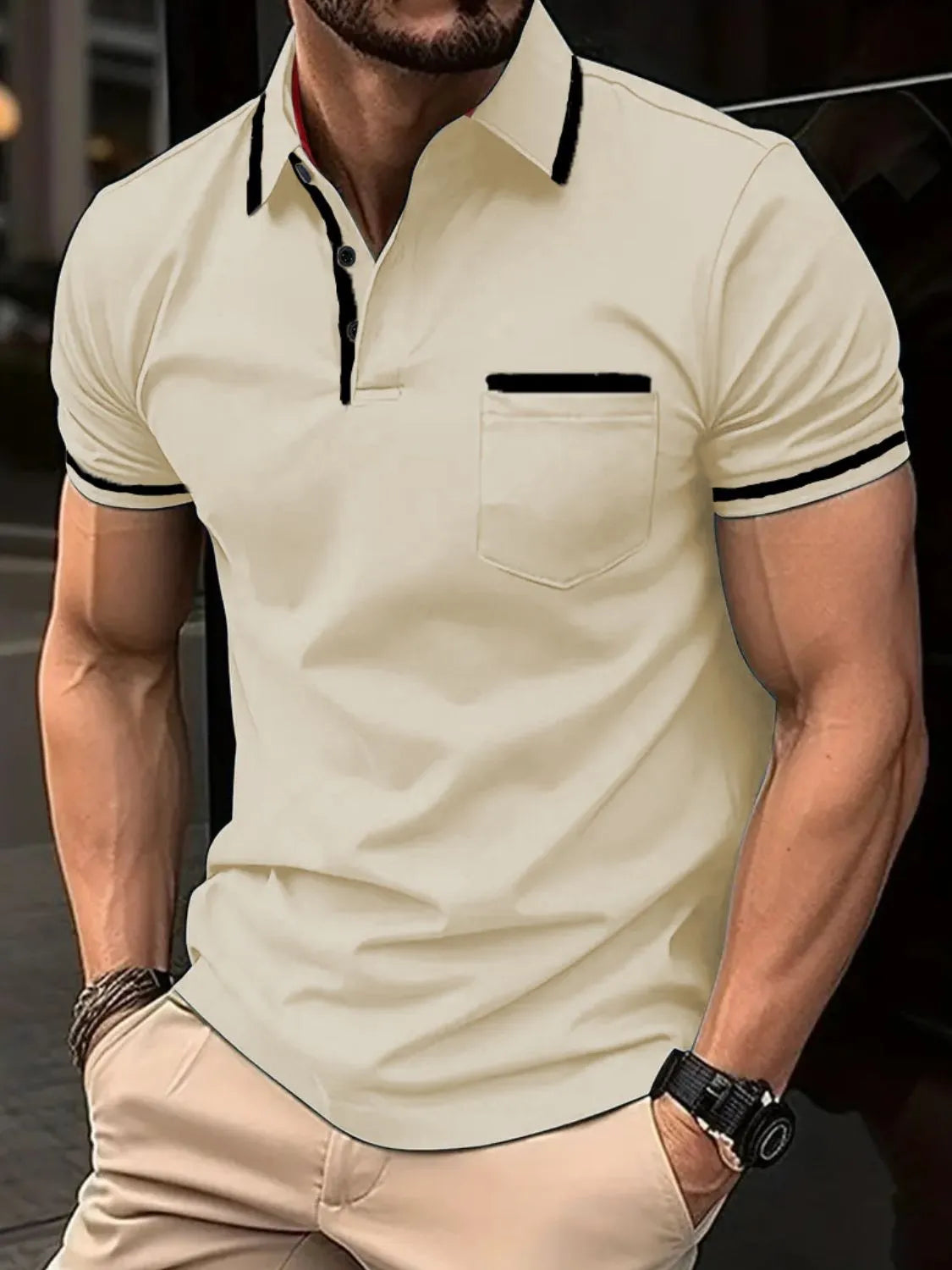 Tan short sleeve polo shirt with black contrast trim on collar, pocket, and sleeves.