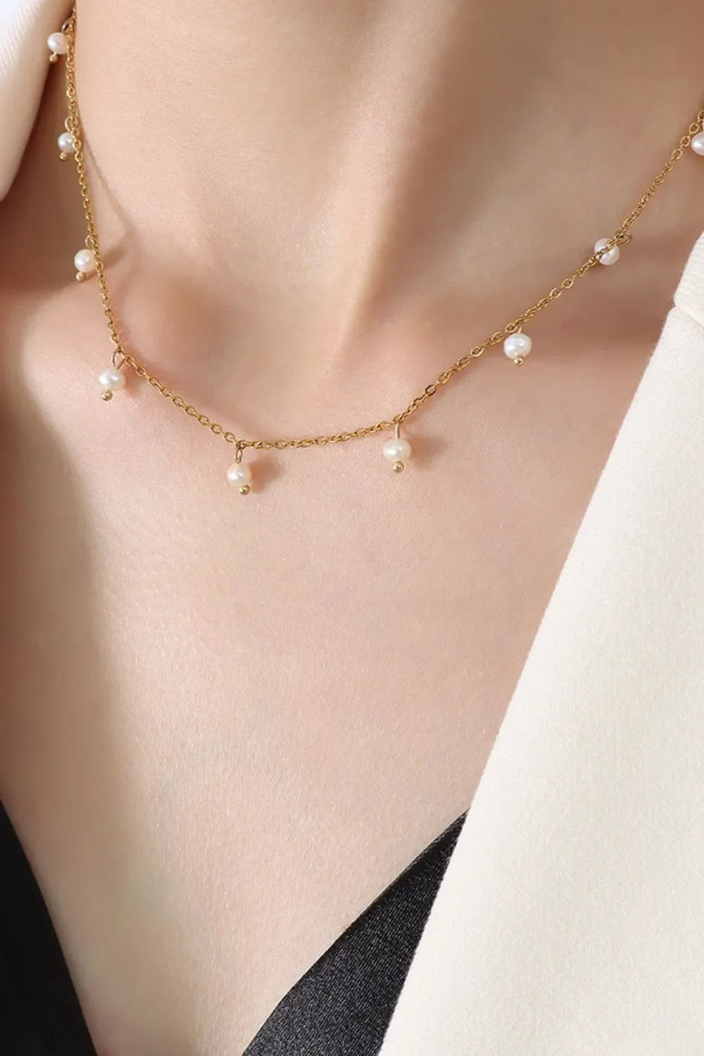Gold chain necklace with dangling pearl accents