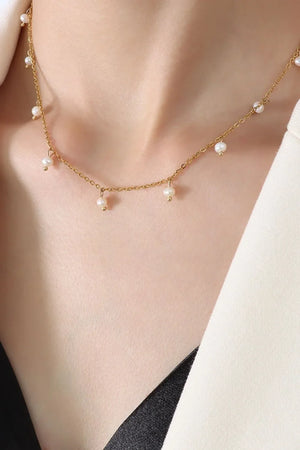 Gold chain necklace with dangling pearl accents