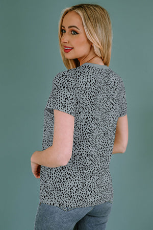 Spotted print crew neck t-shirt in a light grey with black spots, short sleeves.