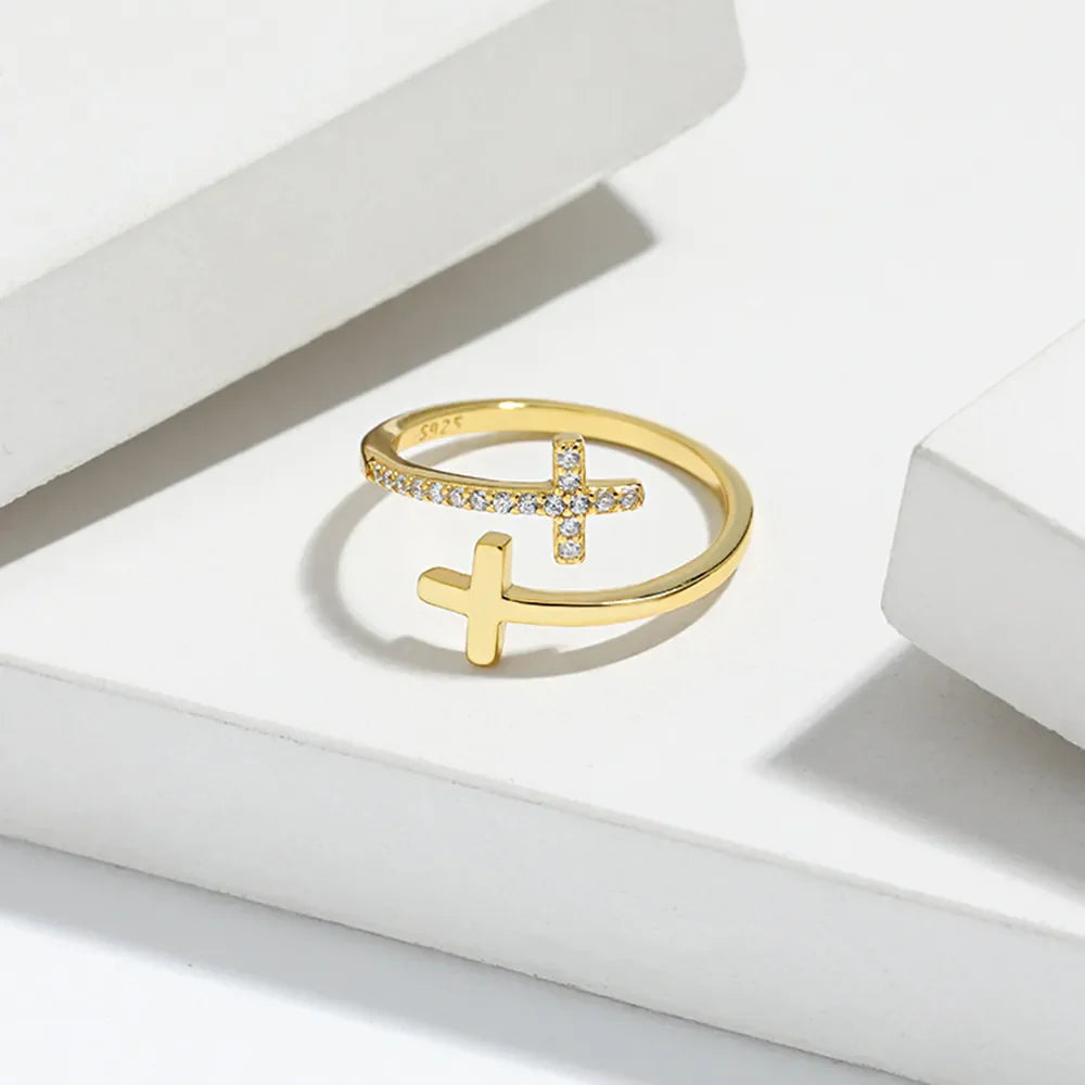 Gold open ring with two crosses, one with pave crystals, made of 925 sterling silver.