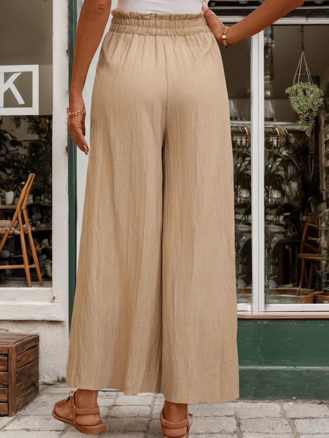 Tan textured wide-leg drawstring trousers with a comfortable elastic waistband.