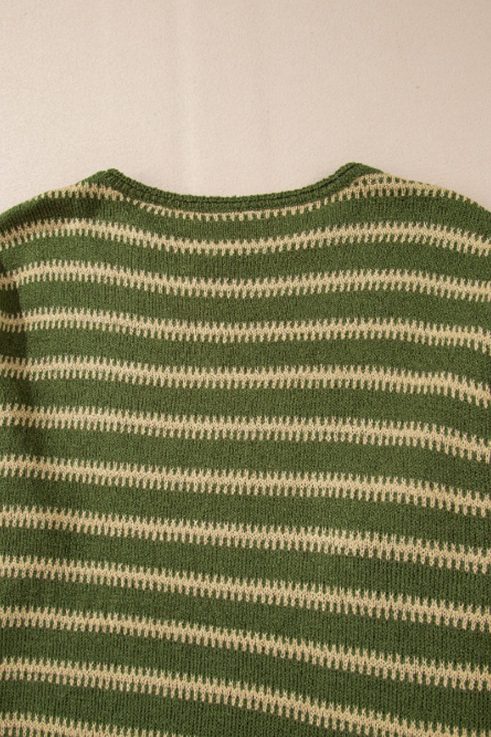 Moss green knit sweater with textured beige stripes and a crew neck.