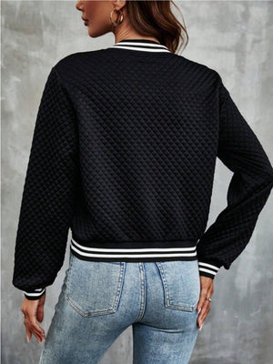 Black quilted bomber jacket with striped ribbing at the collar, cuffs, and hem.