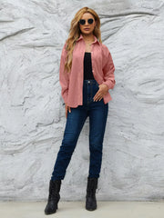 Classic corduroy button-up overshirt in Pinkish, styled open over a black top and jeans.
