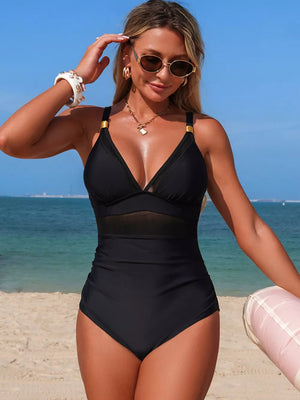 Black one-piece swimsuit with mesh panel detail and gold hardware accents.